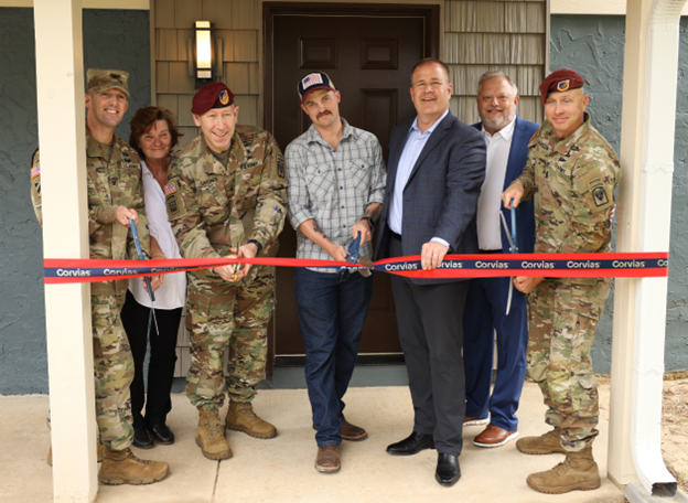 Pictured is Corvias and Army leadership cutting the ribbon on the renovated Berkley Court home assigned to Staff Sergeant Brody Gragg and his family.