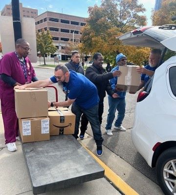 Corvias team members unloading boxes full of donations at the John D. Dingell VA Medical Center in Detroit. 