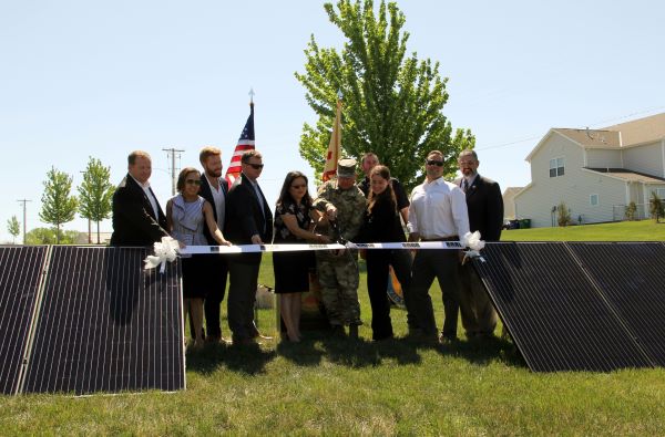 Caption: At Fort Riley, Kansas, representatives from Corvias, their energy partners and the U.S. Army cut the ribbon on a solar project expected to generate $240 million in utility savings over the next 30 years.