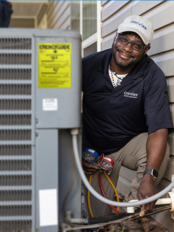 Maintenance Tech works on HVAC system at home