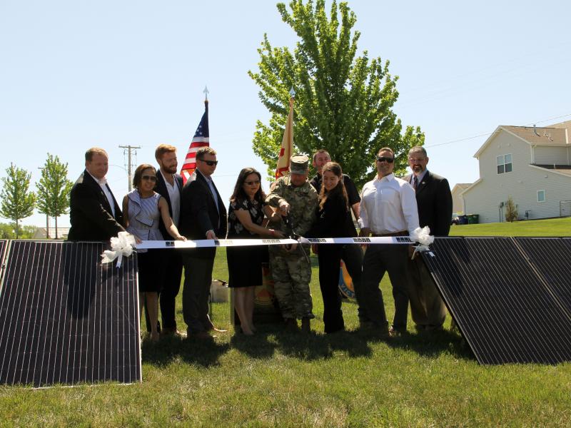 Caption: At Fort Riley, Kansas, representatives from Corvias, their energy partners and the U.S. Army cut the ribbon on a solar project expected to generate $240 million in utility savings over the next 30 years.