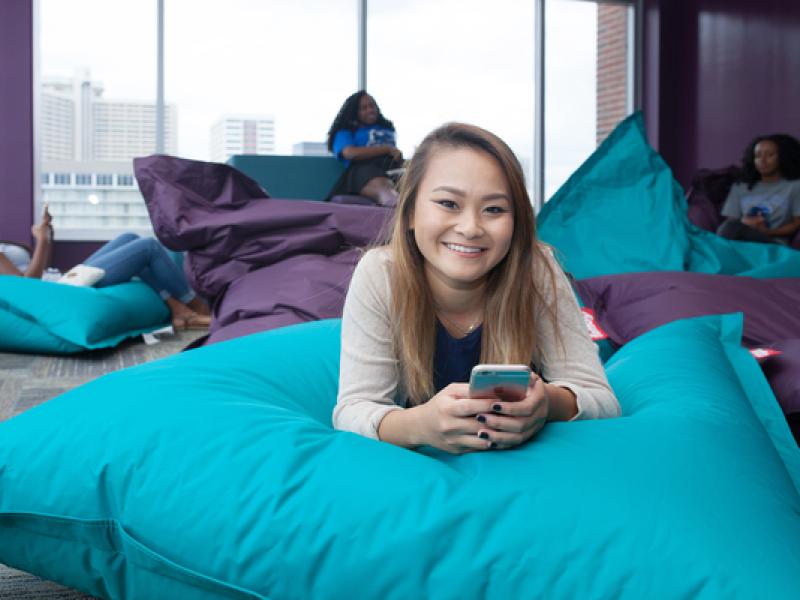 Student enjoys time in dorm common area